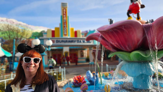 Kelly bounding as Mickey Mouse in Toontown, while standing in front of the fountain