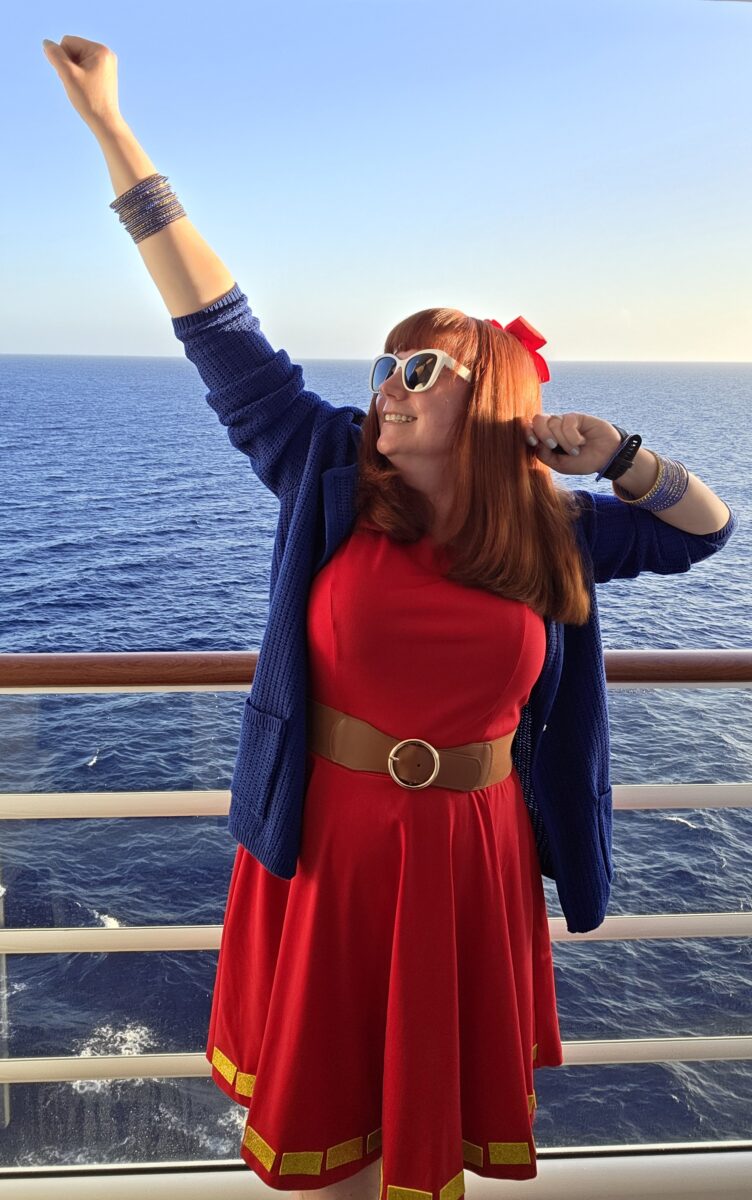 Kelly in her Superhero Minnie bound on a balcony on the Disney Destiny