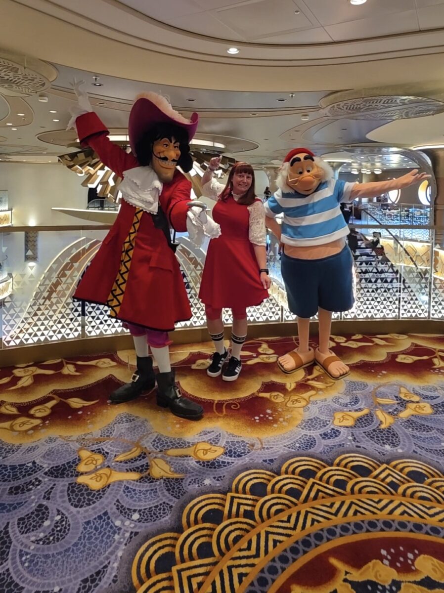 Kelly in her Captain Hook bound with Captain Hook and Mr. Smee on the Disney Destiny