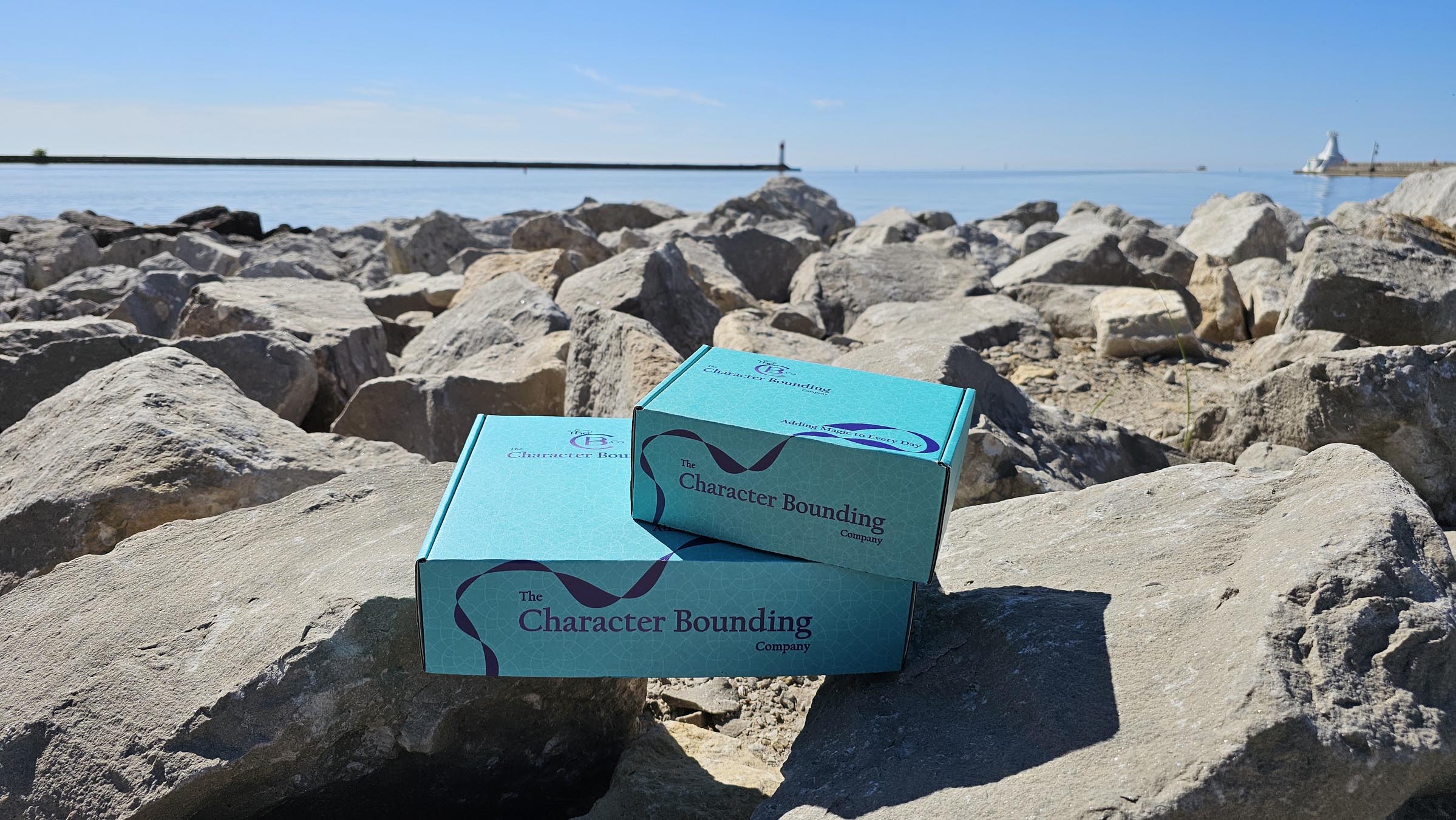 TheCB.Co boxes on rocks with water in the background