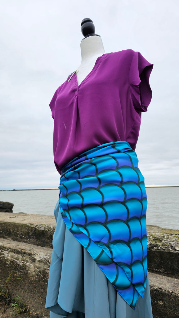 Detailed shot of accessories from the Mermaid Princess Bounding Box on mannequin with water in the background