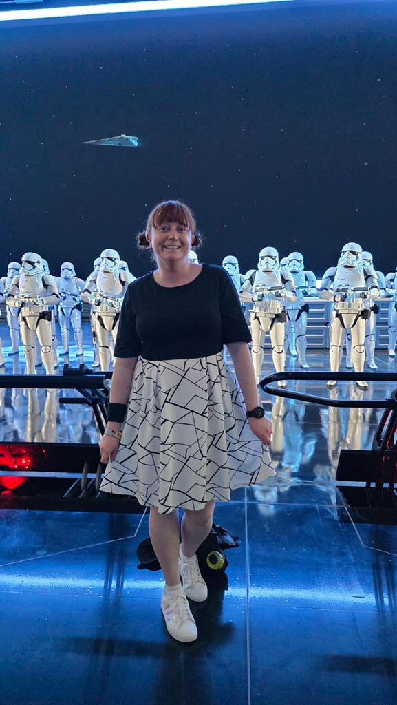 Kelly bounding as a Stormtrooper in front of a line of Stormtrooper at Star Wars: Galaxy’s Edge in Disney’s Hollywood Studios