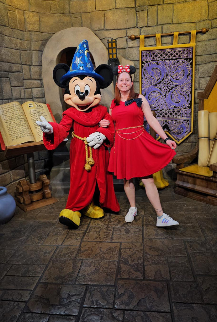 Kelly bounding as Sorcerer Mickey while standing with Sorcerer Mickey at Disney’s Hollywood Studios