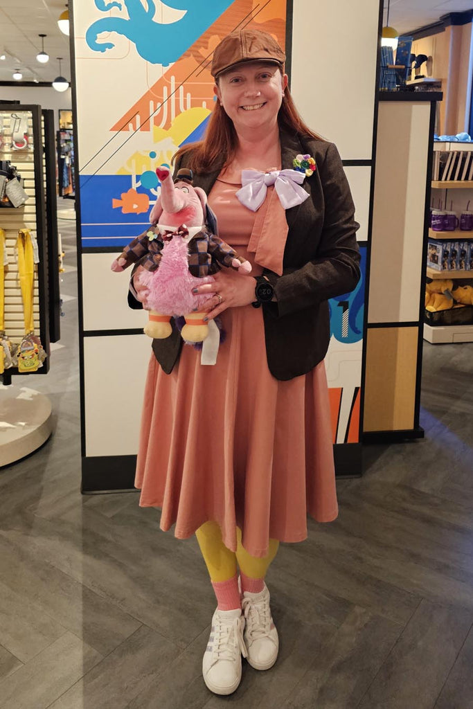Kelly bounding as Bing Bong while holding a stuffy version of Bing Bong