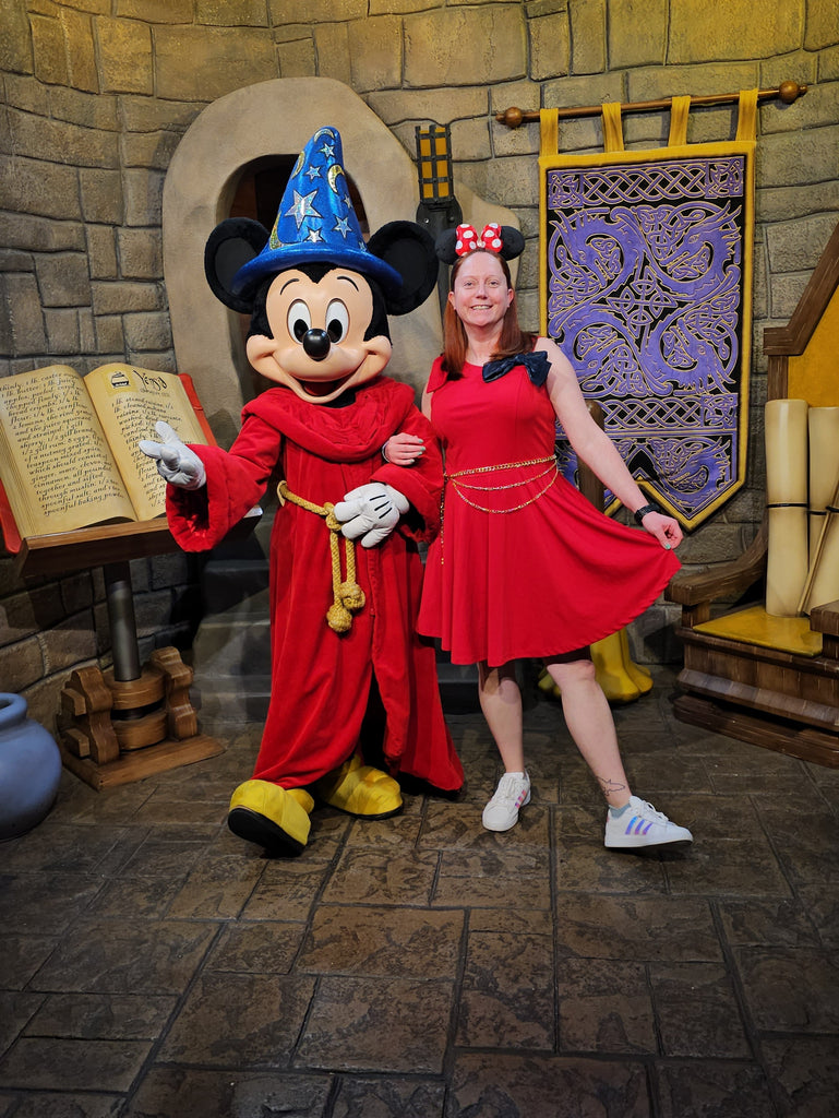 Kelly bounding as Sorcerer Mickey while posing for a photo with Sorcerer Mickey