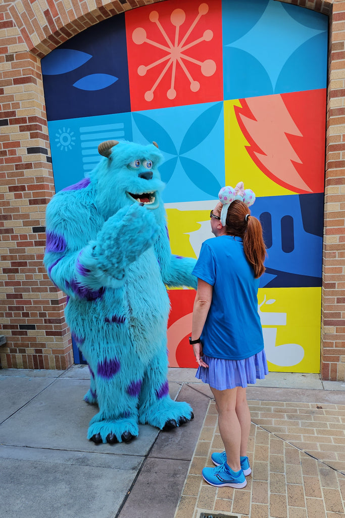 Kelly bounding as Sulley from Monsters Inc while meeting Sulley