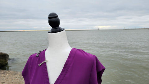 Detailed shot of accessories from the Mermaid Princess Bounding Box on mannequin with water in the background