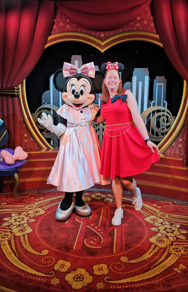 Kelly bounding as Sorcerer Mickey while standing with Minnie Mouse at Disney’s Hollywood Studios