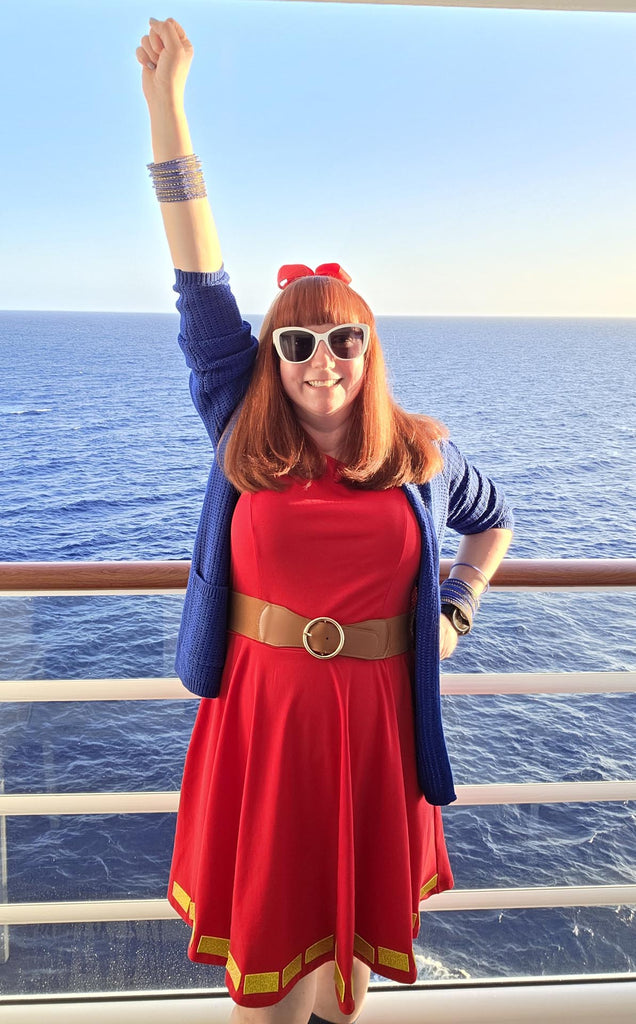 Kelly bounding as Superhero Minnie on a balcony on the Disney Destiny