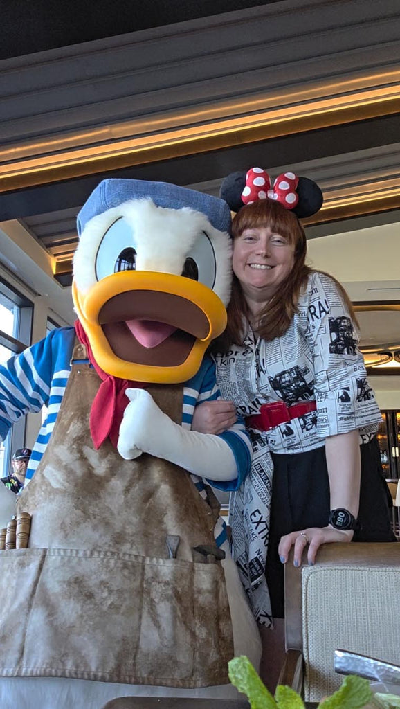 Kelly bounding as Poet Minnie with Donald Duck at Topolino’s Terrace