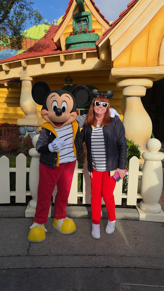 Kelly bounding as Mickey Mouse next to Mickey Mouse in Toontown
