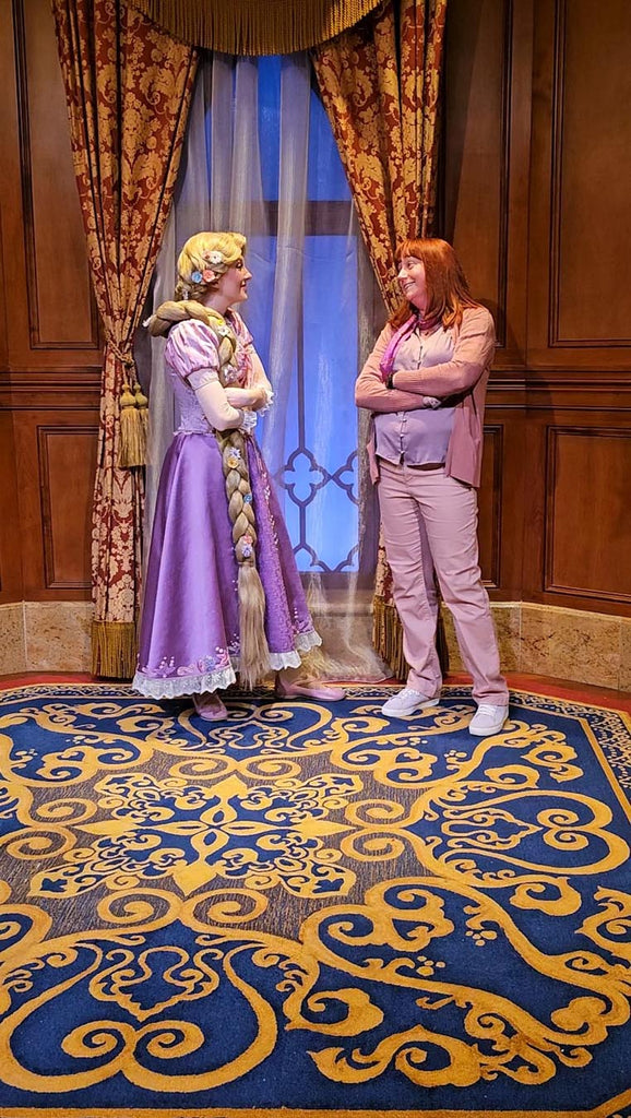 Kelly bounding as Rapunzel while meeting Rapunzel at Magic Kingdom