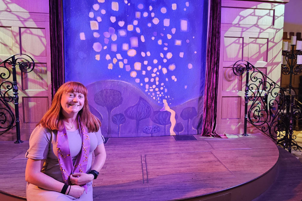 Kelly bounding as Rapunzel on the stage at Rapunzel’s Royal Table