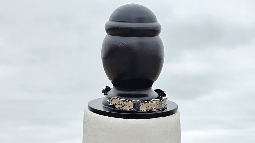 Detailed shots of the eel bangle from the Sea Witch bounding boxes on mannequin at a beach with sand and water in the background