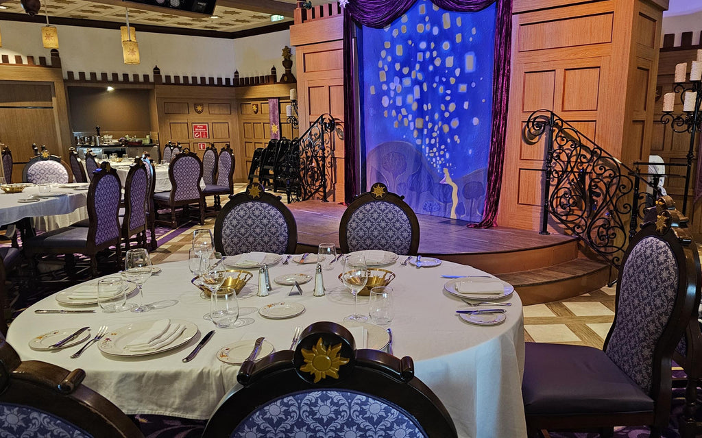table setting with stage in the background at Rapunzel’s Royal Table on the Disney Magic
