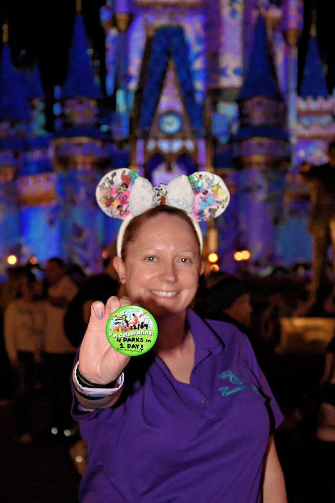 Kelly in front of Cinderella Castle with her 4 Parks 1 Day Celebration Button