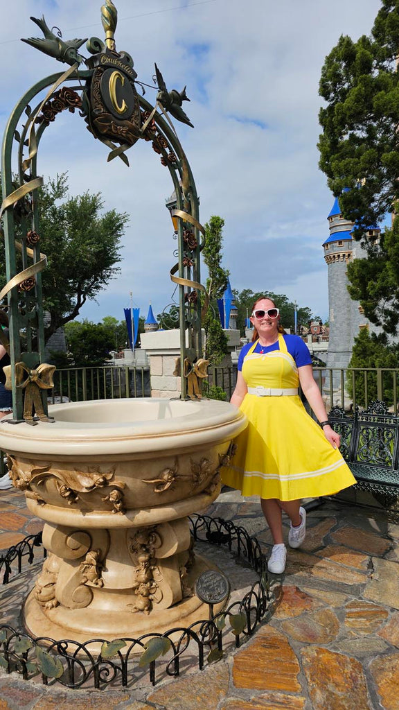 Kelly bounding as Dapper Snow White at Magic Kingdom by the Cinderella Fountain