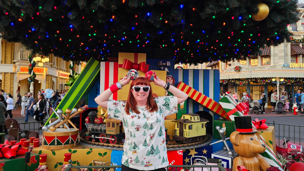 Kelly in front of the Christmas tree at Magic Kingdom