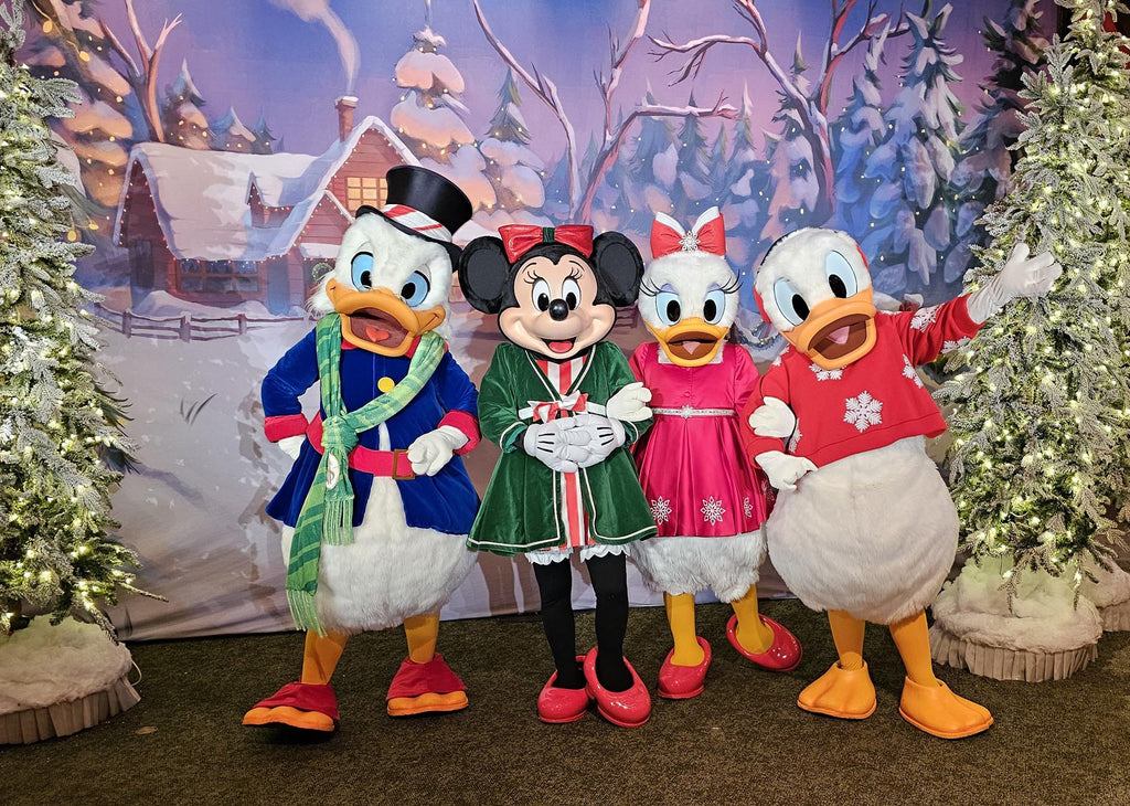 Scrooge, Minnie Mouse, Daisy and Donald in Christmas outfits at a Magic Kingdom Meet and Greet