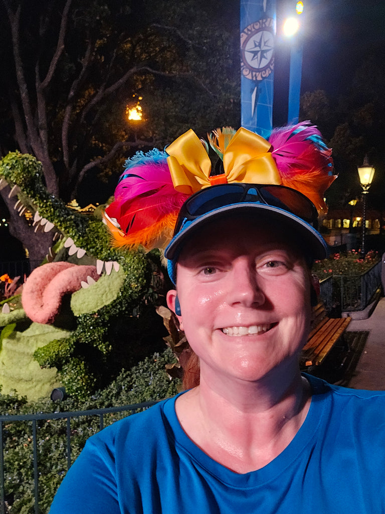 Kelly stopping for a photographic with a crocodile topiary in Epcot during the RunDisney 2024 RunDisney Springtime Surprise 10K