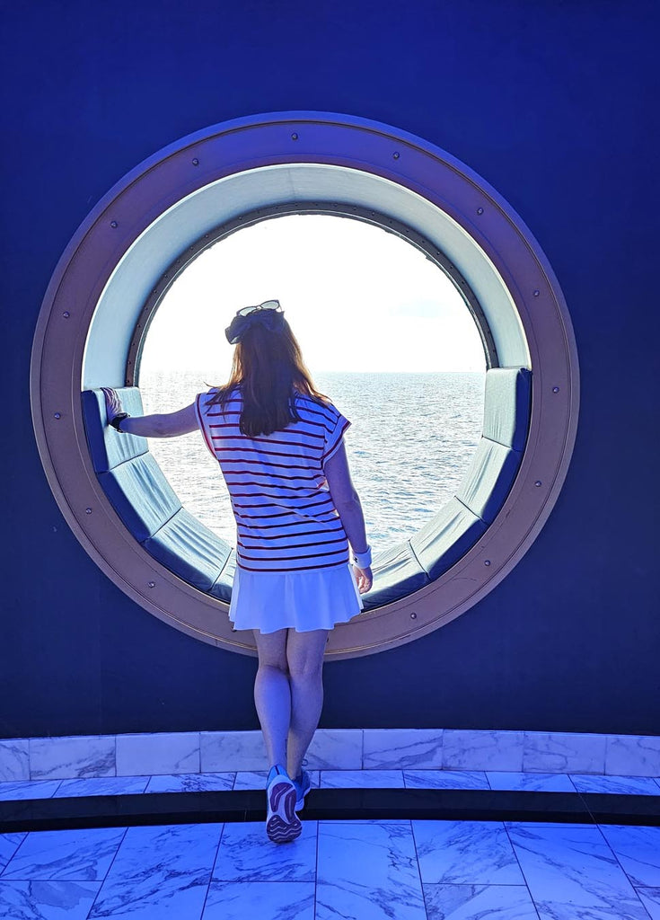 Kelly bounding as Cruise Donald and looking out the window on the Disney Magic