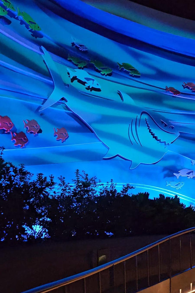 Shark and fish artwork on the exterior of The Seas with Nemo & Friends building