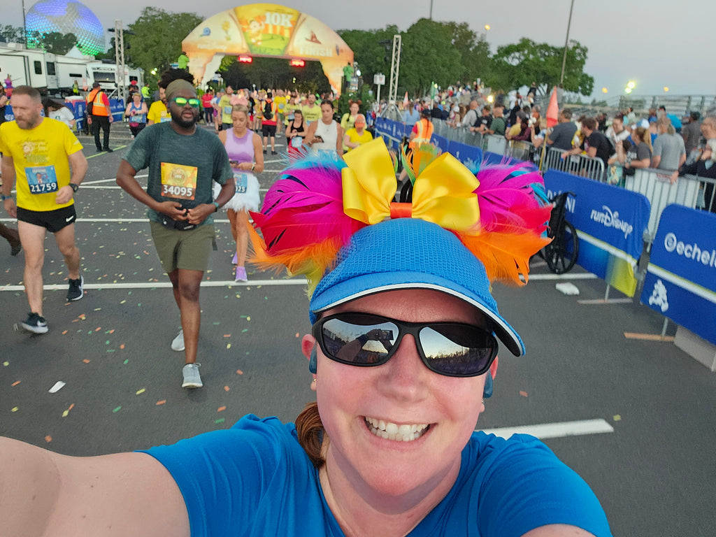 Kelly having crossed the finish line with spectators and other runners around her