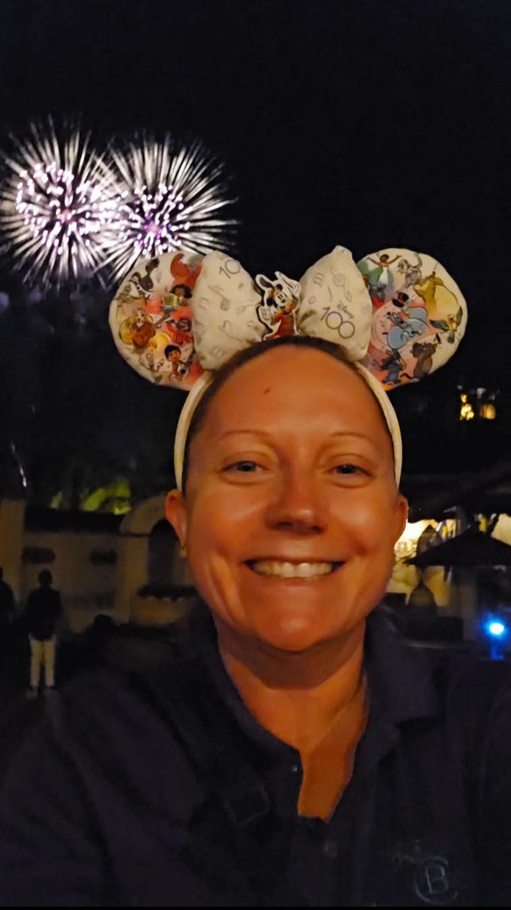 Kelly with fireworks in the background at Magic Kingdom
