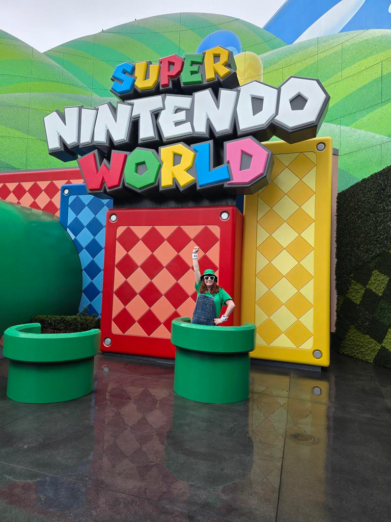 Kelly in a green warp tube at the entrance to Super Nintendo World