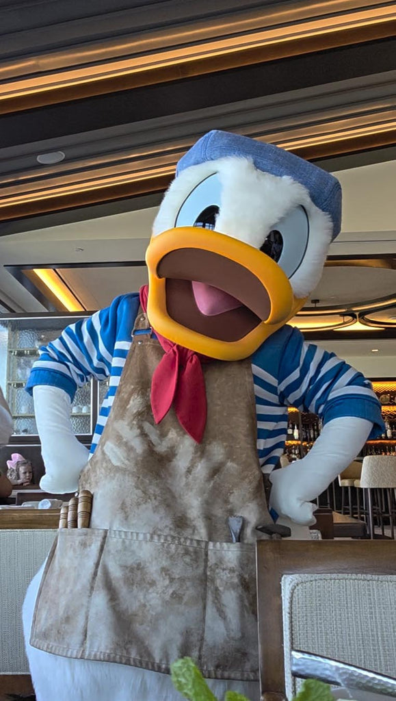 Donald Duck dressed as a sculptor at Disney’s Riviera Resort