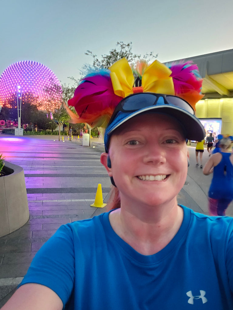 Kelly running in the 2024 Springtime Surprise race with the Epcot geosphere in the background
