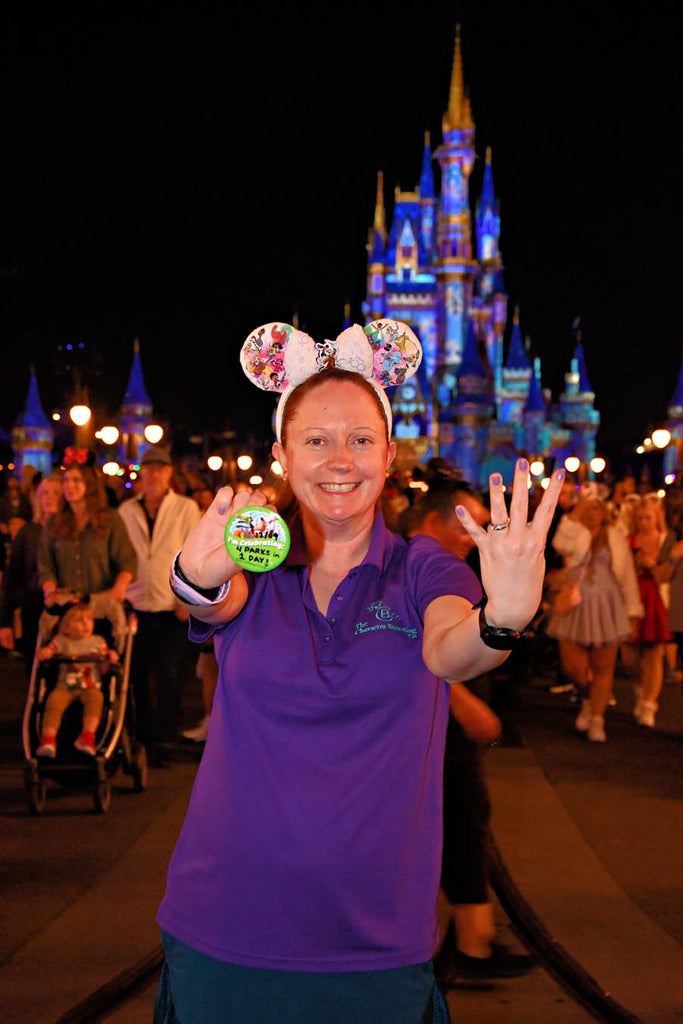 Kelly in front of Cinderella Castle with her 4 Parks 1 Day Celebration Button