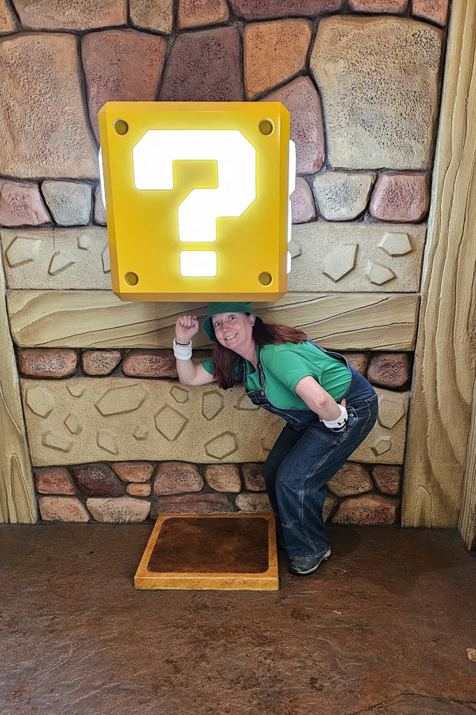 Kelly bounding as Luigi while in Super Nintendo World