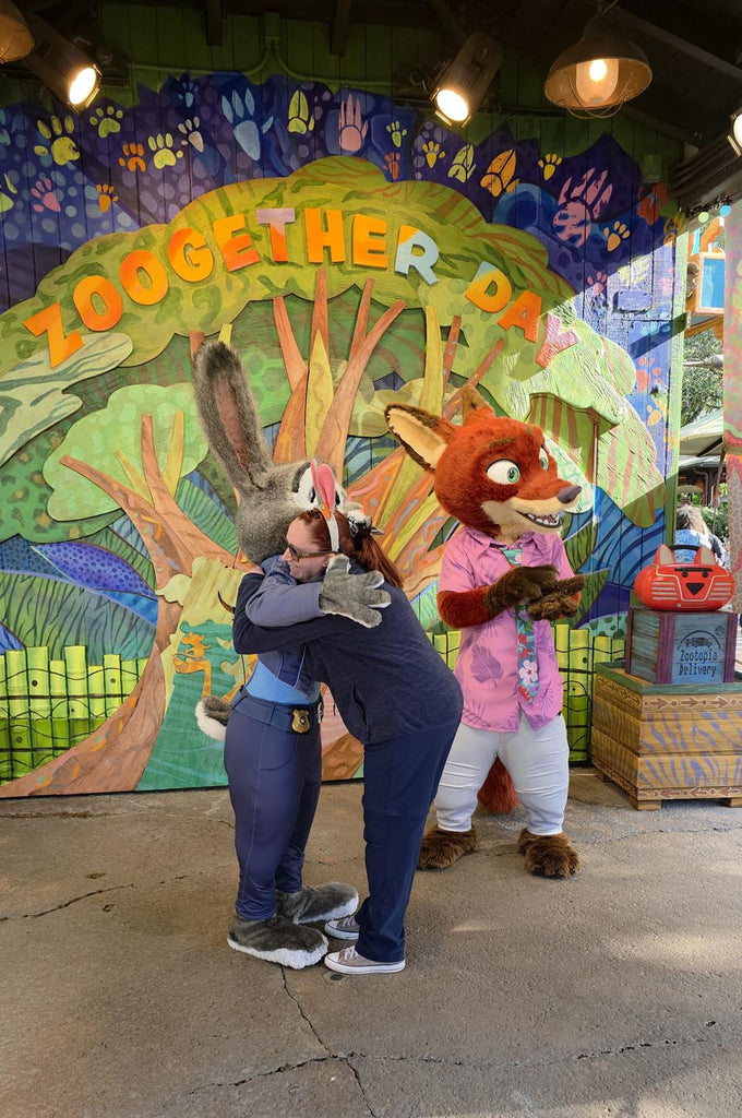 Kelly bounding as Judy Hopps while hugging Judy Hopps and Nick Wilde at Disney’s Animal Kingdom