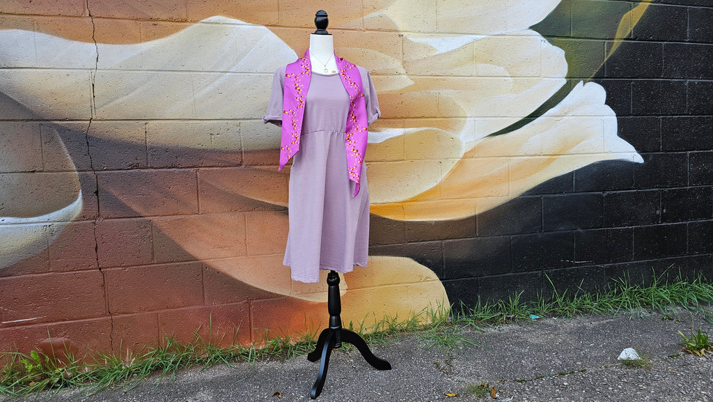 Rapunzel bound on mannequin with flower mural in the background
