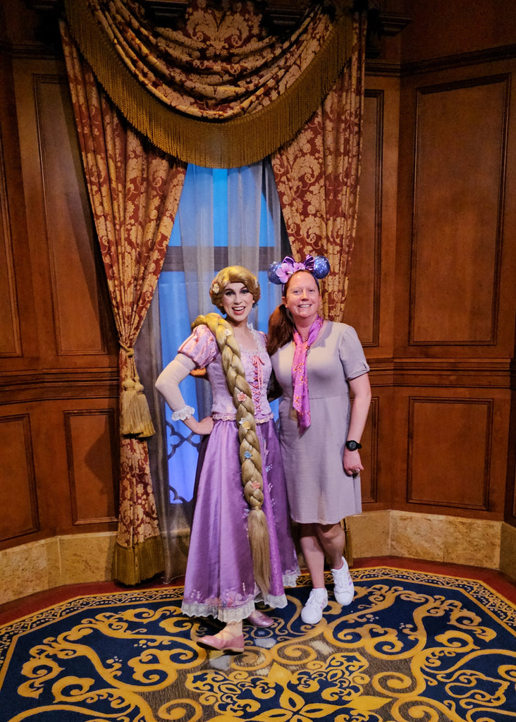 Kelly bounding as Rapunzel while posing with Rapunzel