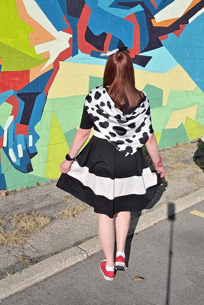 Kelly bounding as Cruella, facing away from the camera