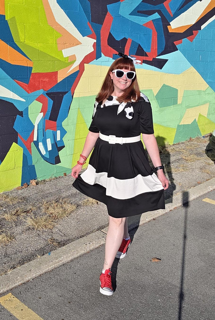 Kelly bounding as Cruella walking towards the camera