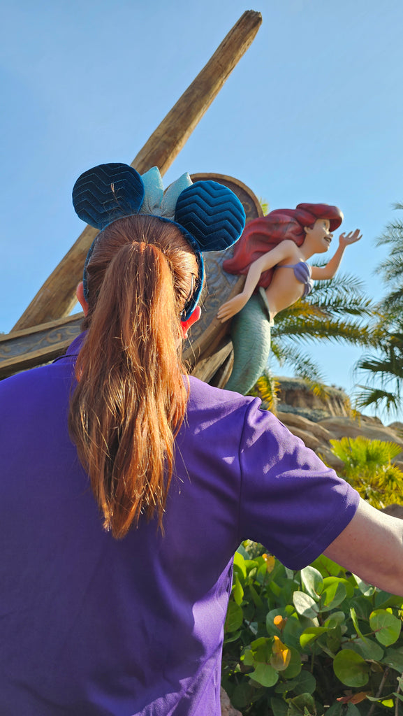Kelly standing in front of the Ariel statue of Under the Sea – Journey of the Little Mermaid in Magic Kingdom