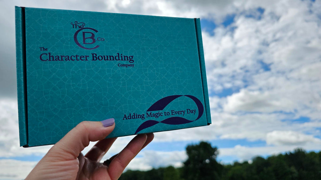 A bounding box from TheCB.Co being held with more trees and blue sky in the background