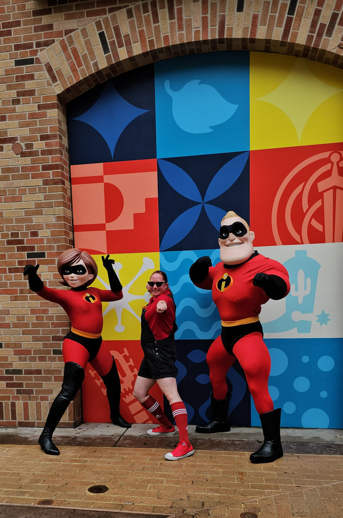 Kelly bounding as Mrs. Incredible, was posing for a photo with Mrs. Incredible and Mr. Incredible