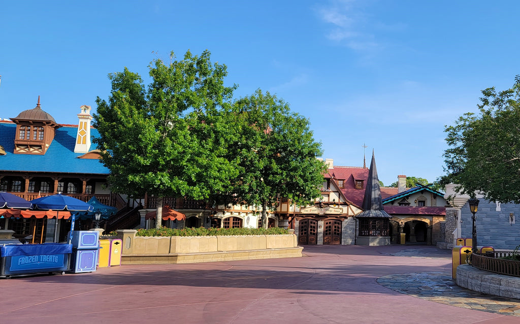 Fantasyland pathway including food cart by Pinocchio village Haus