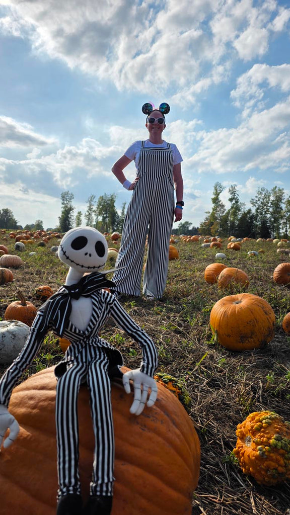 Kelly bounding as Jack Skellington while in a pumpkin patch