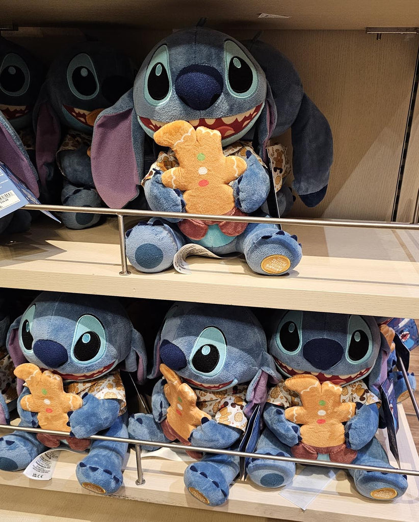 plush Stitch holding a gingerbread cookie
