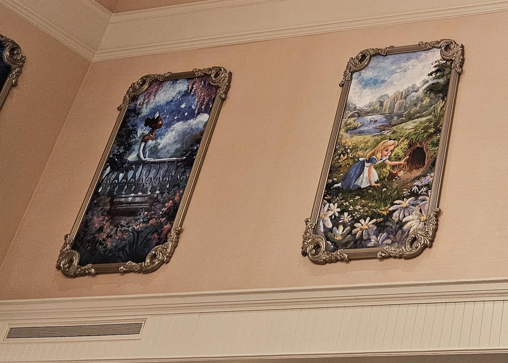 paintings of Tiana and Alice hanging in 1900 Park Fare