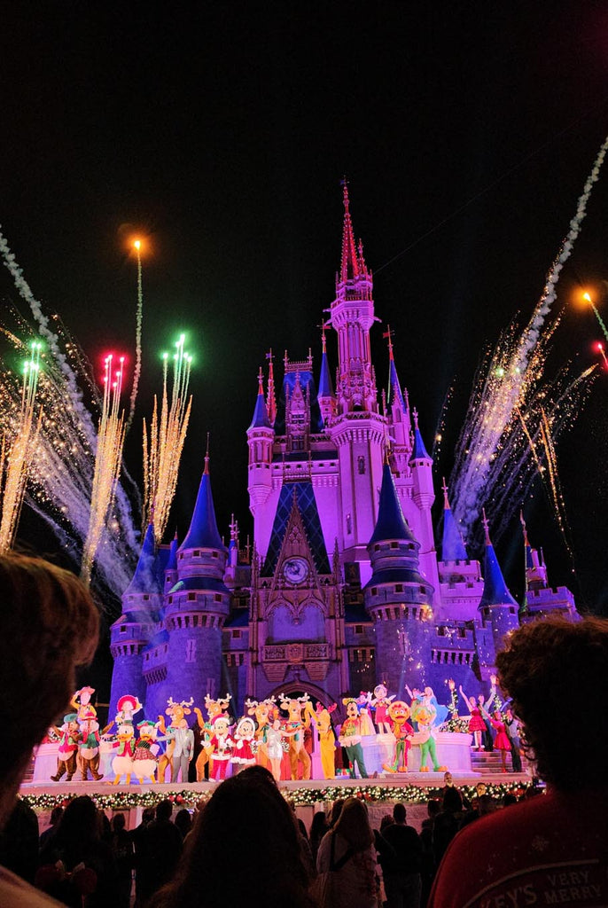 Fireworks at Magic Kingdom with multiple Disney characters on stage