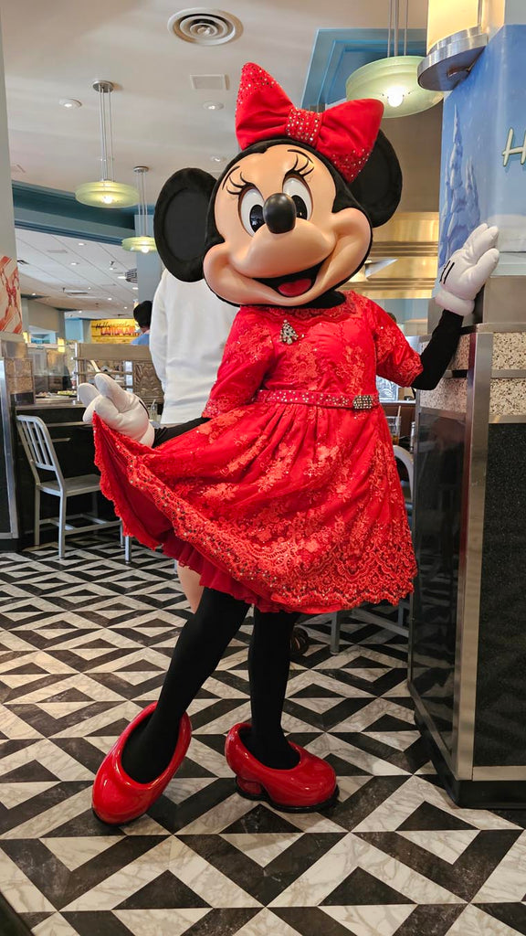 Minnie Mouse dressed in a red Christmas dress at Hollywood & Vine