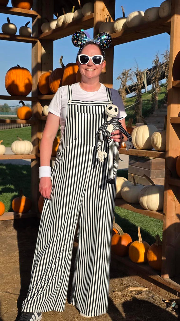 Kelly bounding as Jack Skellington while in a pumpkin patch
