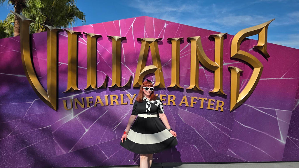 Kelly bounding as Cruella in front of the Disney Villains: Unfairly Ever After sign at Disney’s Hollywood Studios