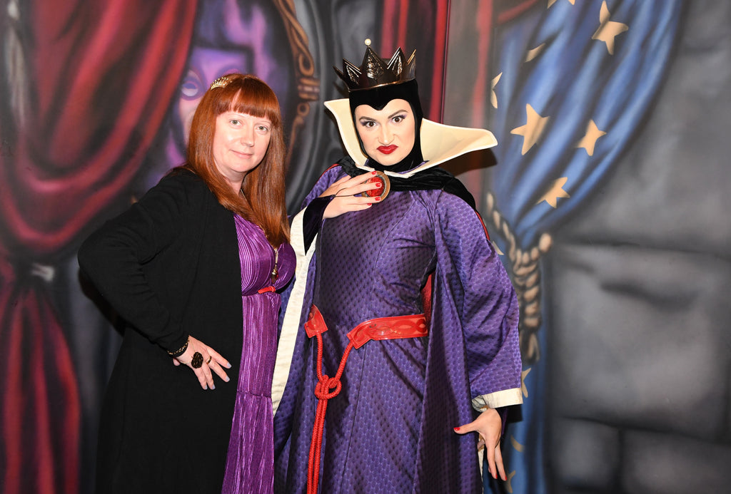 Kelly bounding as the Evil Queen while posing for a photo with the Evil Queen
